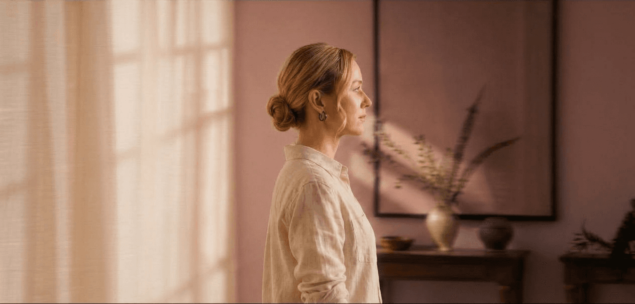 Woman in a warm terracotta room