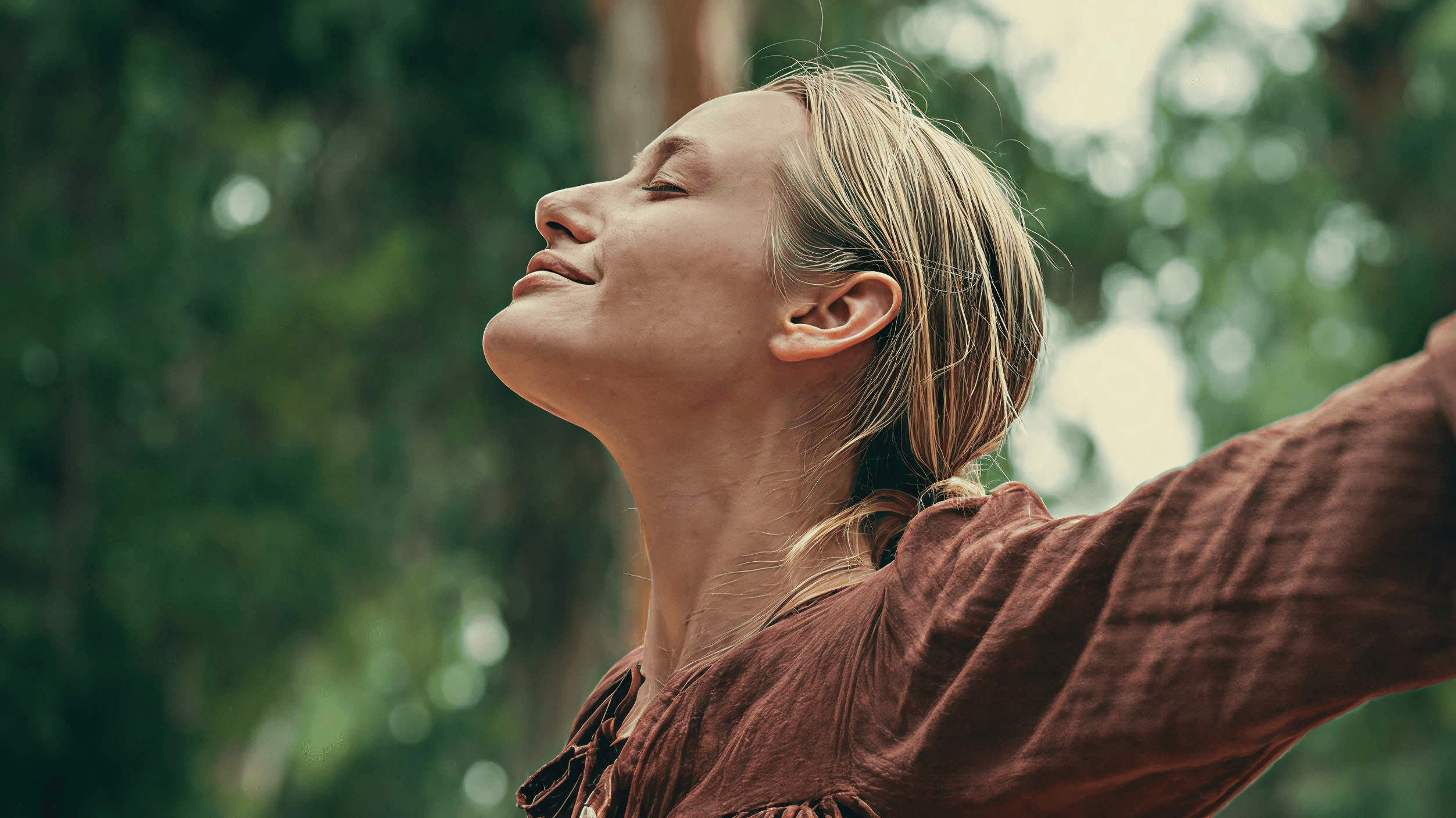 Woman with her face raised to the sun